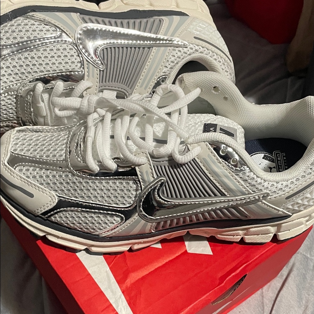 Cute women’s metallic Nike White and Silver Sneakers.